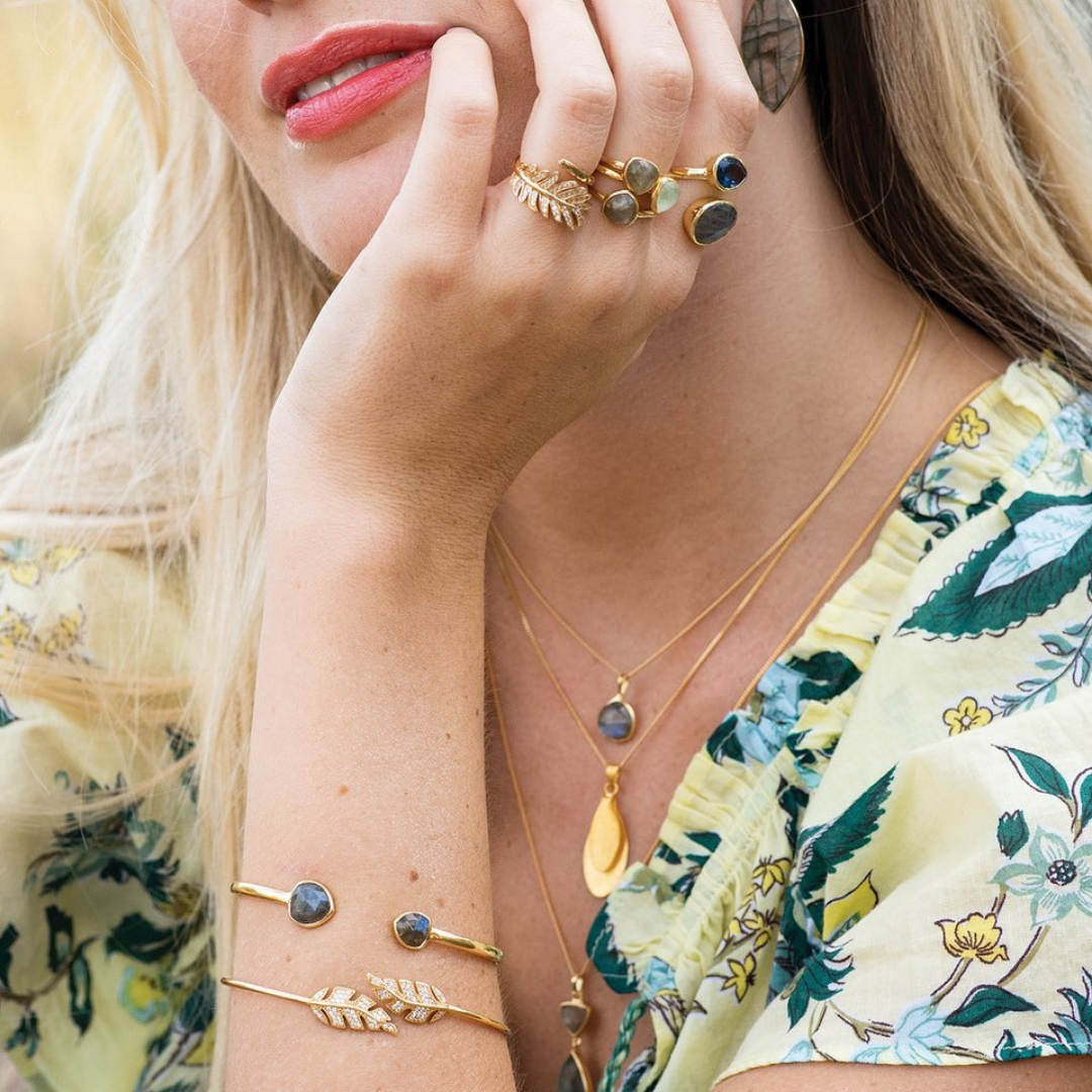 Woman wearing two gold bracelets by Sarah Alexander