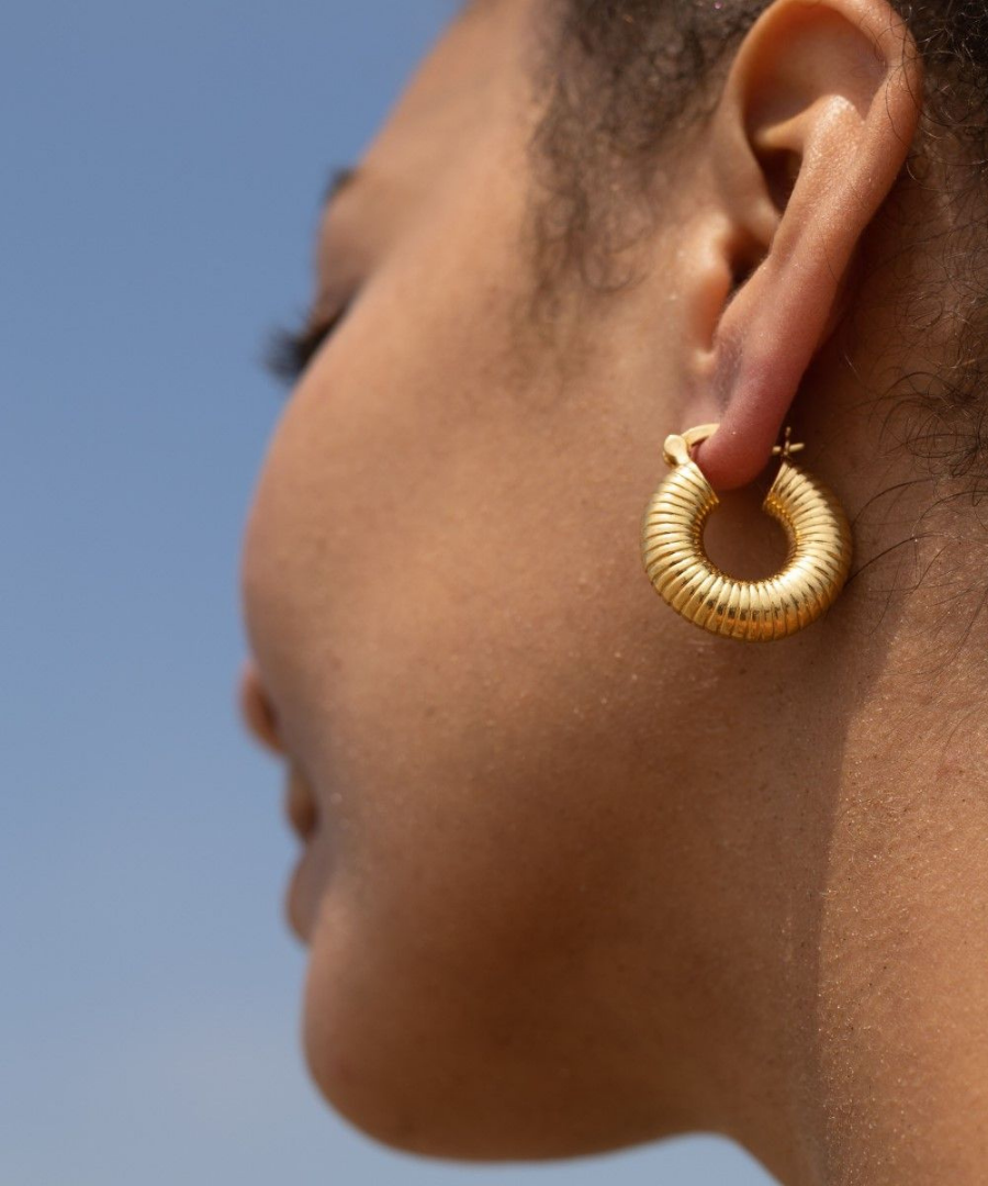 Model wearing Shyla jewellery's gold hoop earrings
