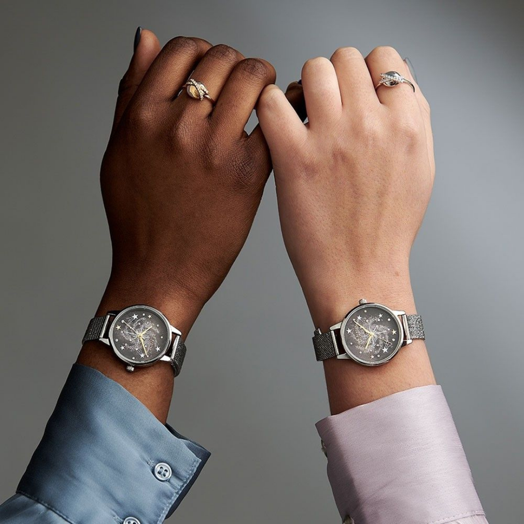 Two models wearing Olivia burton watches holding hands