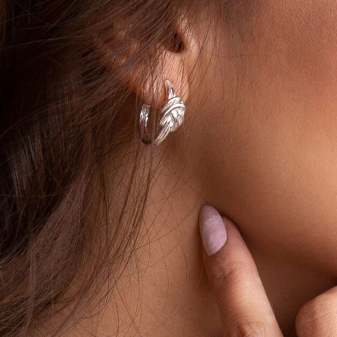 Model wearing annie haak silver knot earrings