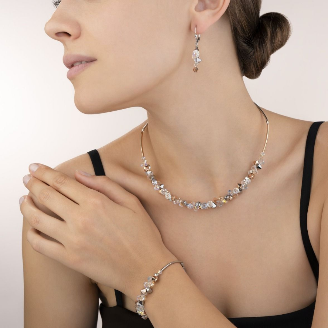 Woman wearing necklace bracelet and earrings by coeur de leon