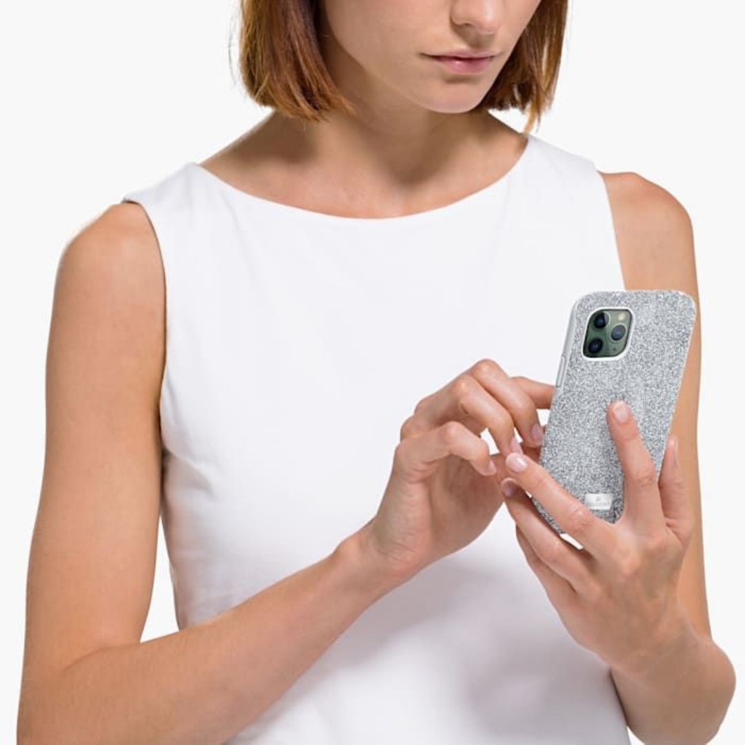 Woman holding a phone in a silver swarovski case