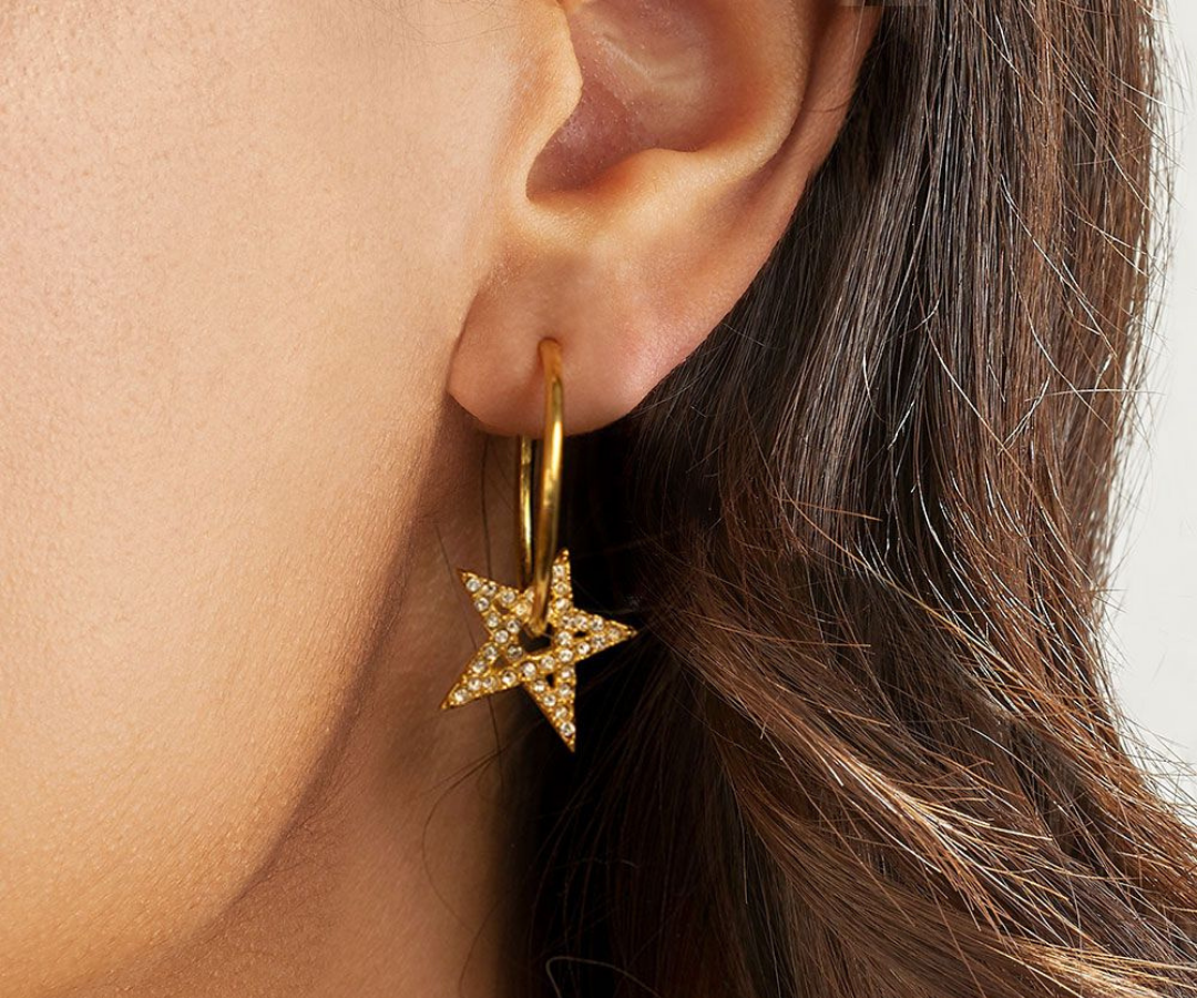 Photo of woman wearing annie haak star sparkle hoop earrings