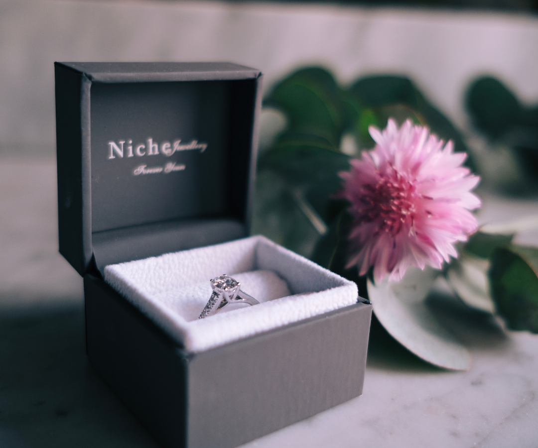 photograph of an engagement ring in a box branded Niche jewellery