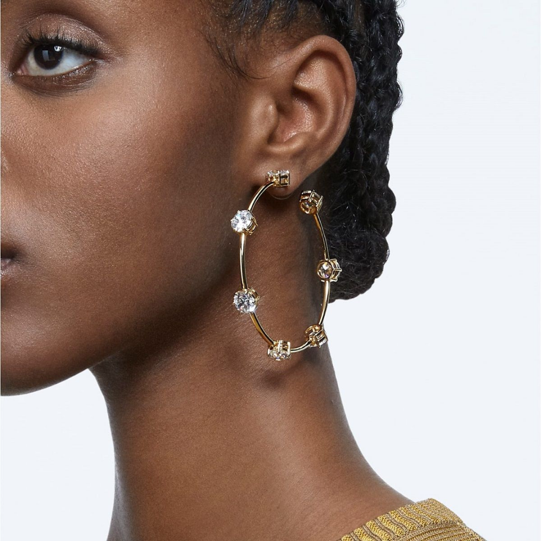 Photograph of a woman wearing an earring made by swarovski