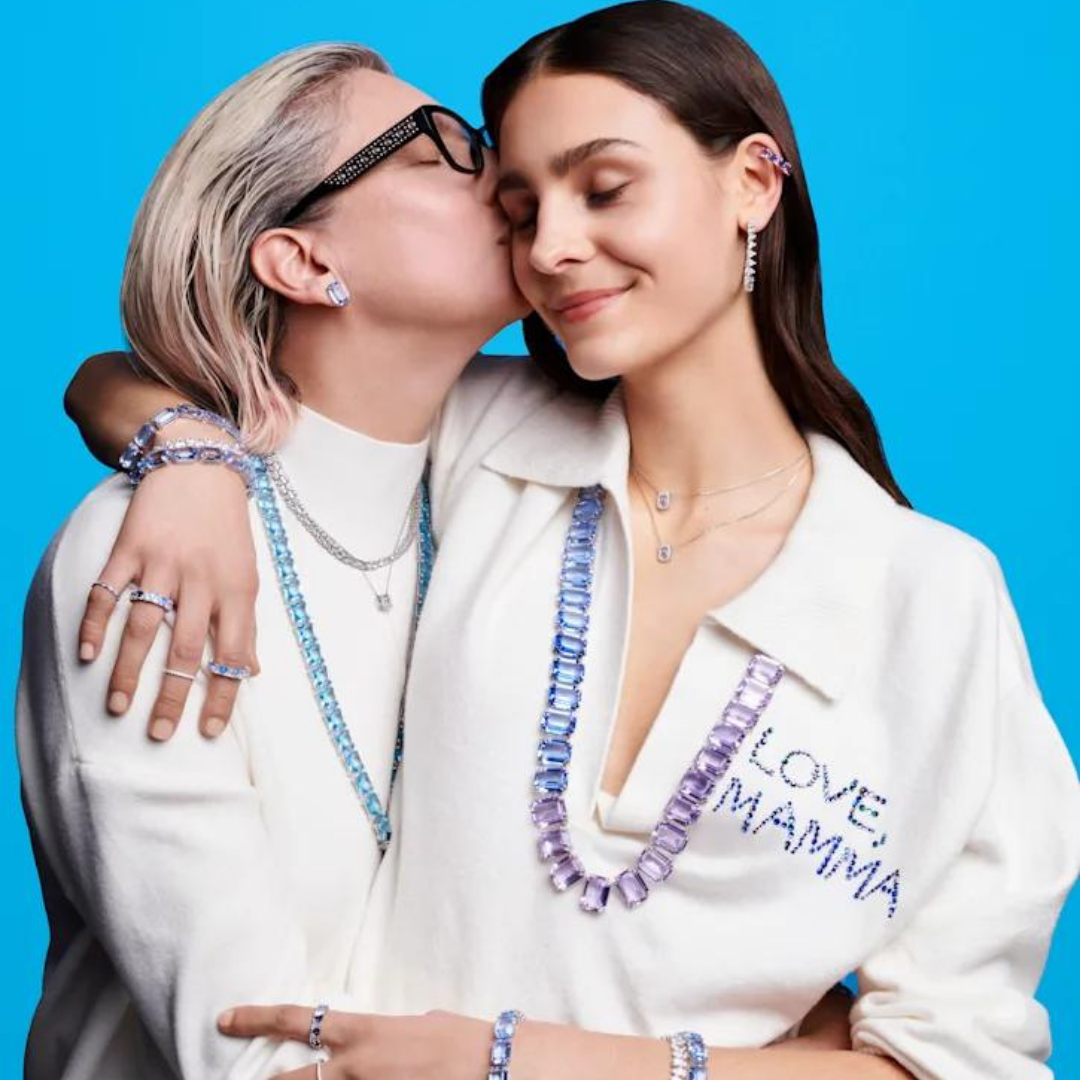 Photograph of two women embracing, they are depicting a mother and daughter and wearing jewellery by Swarovski