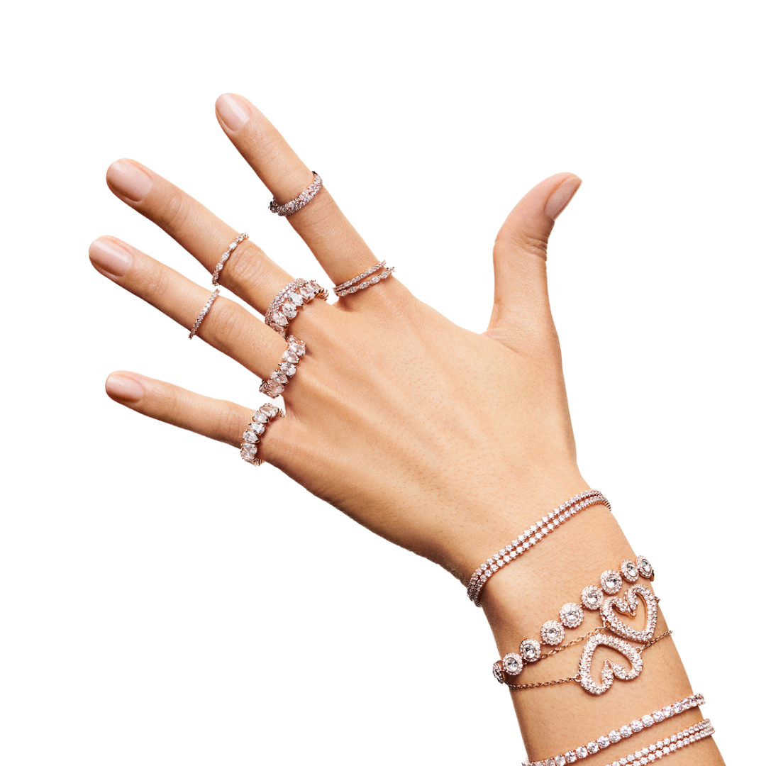 Photograph of a hand wearing several rings and bracelets by swarovski