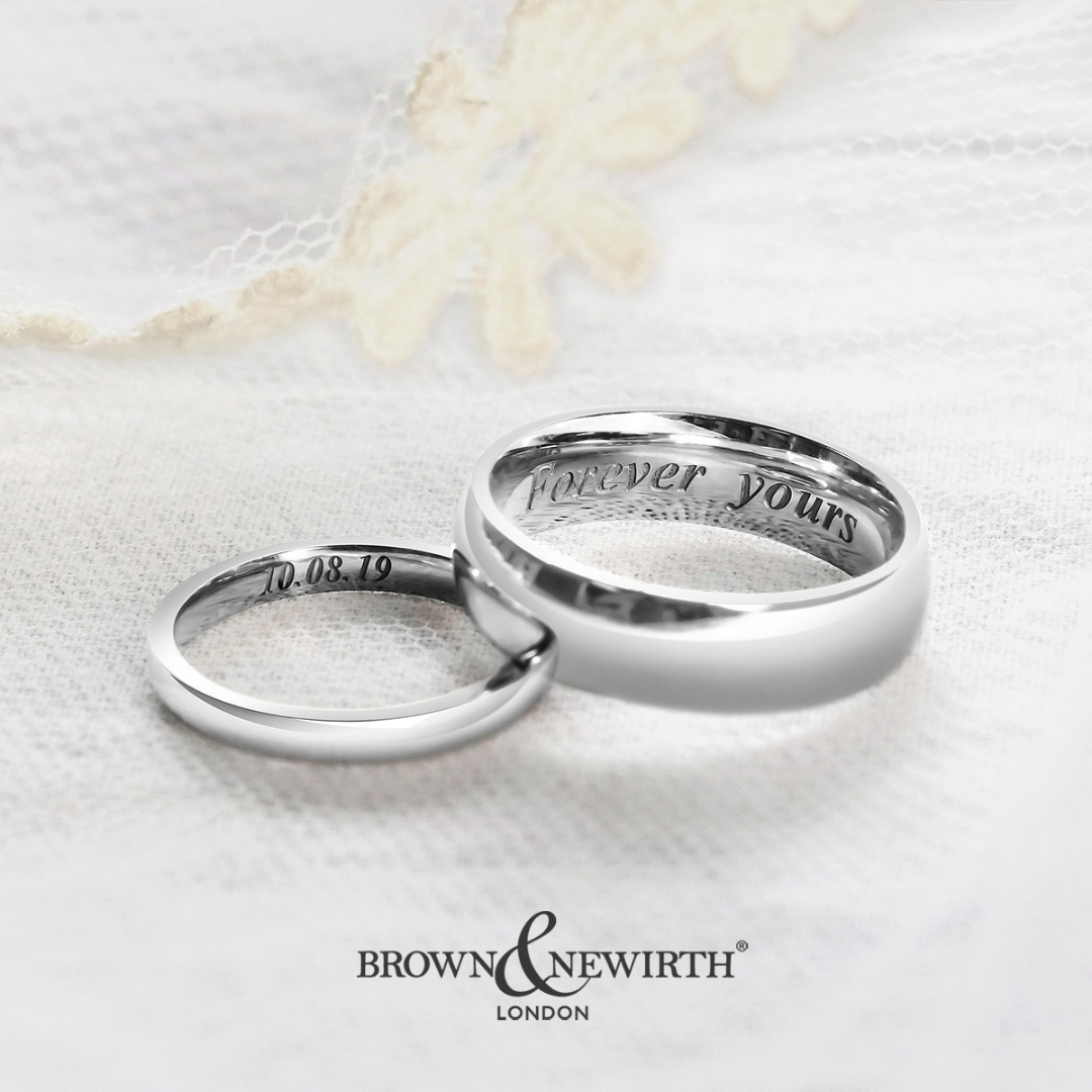 Photograph of his and hers wedding bands in white gold