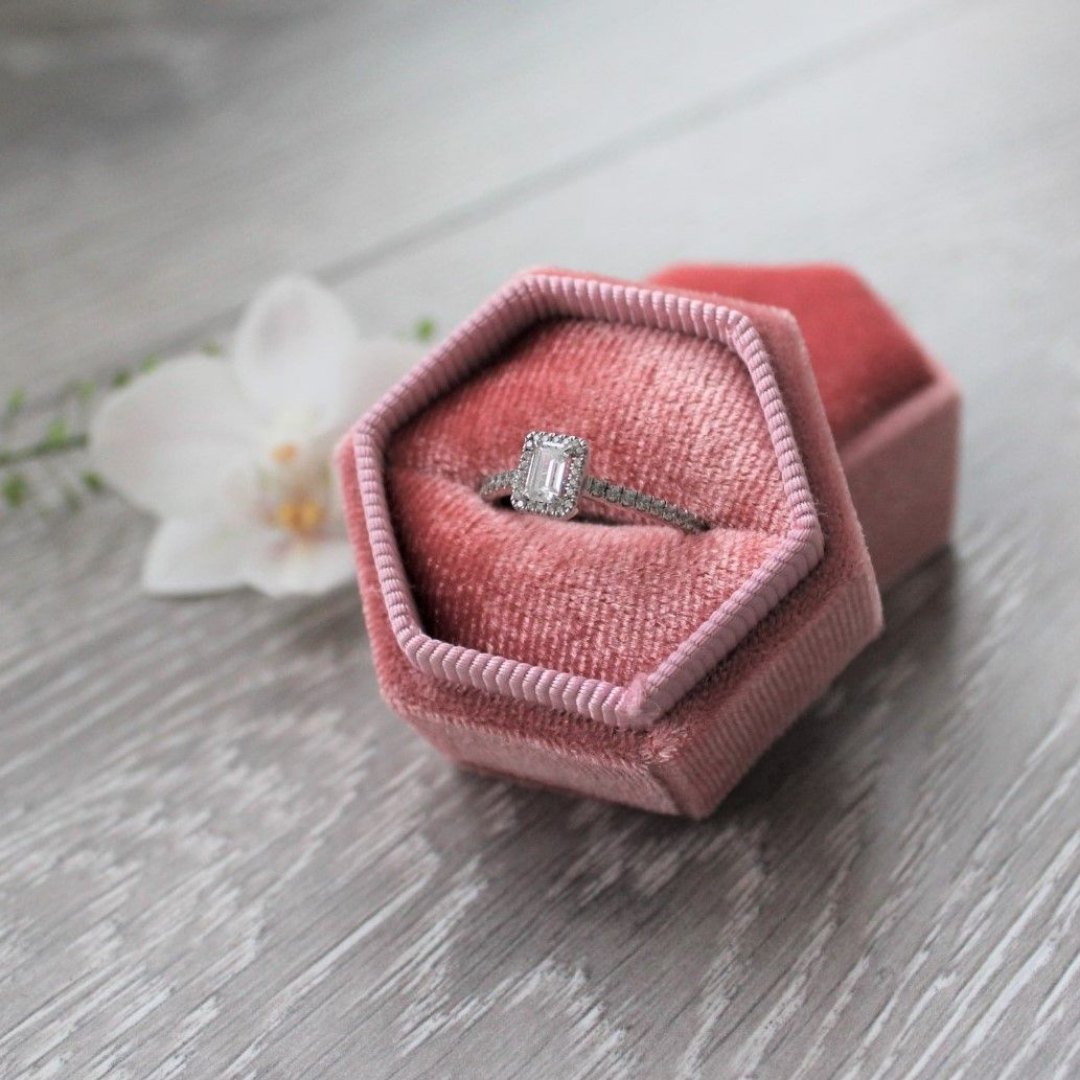 Image of an engagement ring in a pink box