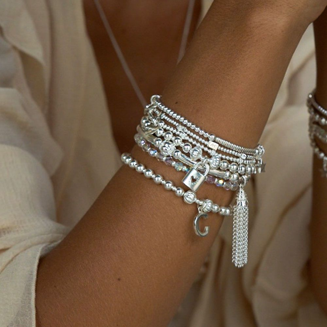 Model wearing annie haak silver bracelet stack